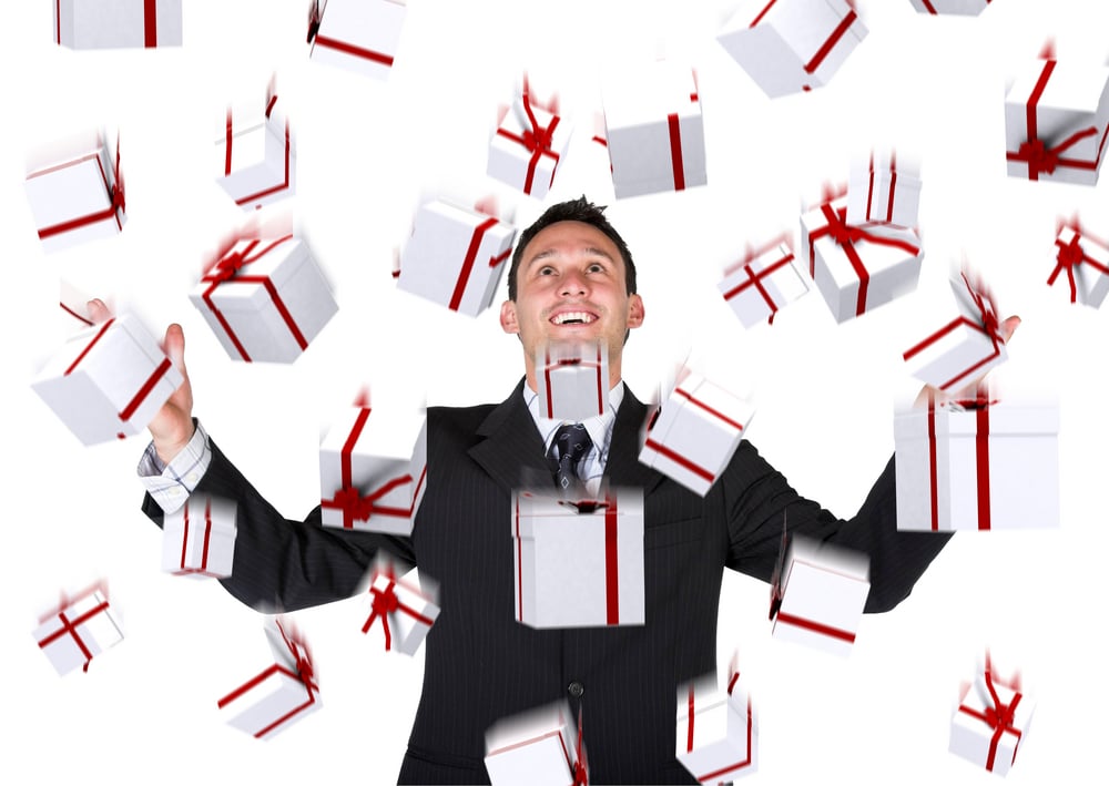 gifts falling down on a business man over a white background