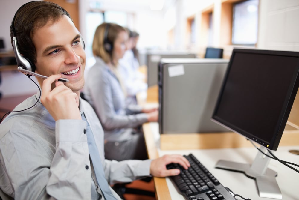 Smiling assistant using a headset in a call center-1