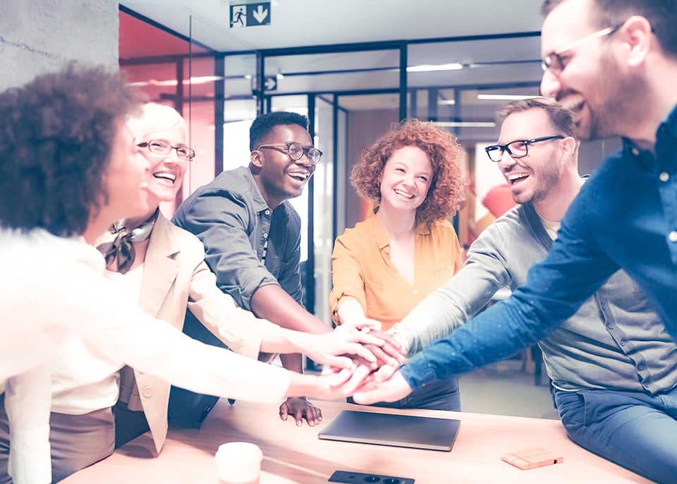 Group of employees joining hands_filter_700x500