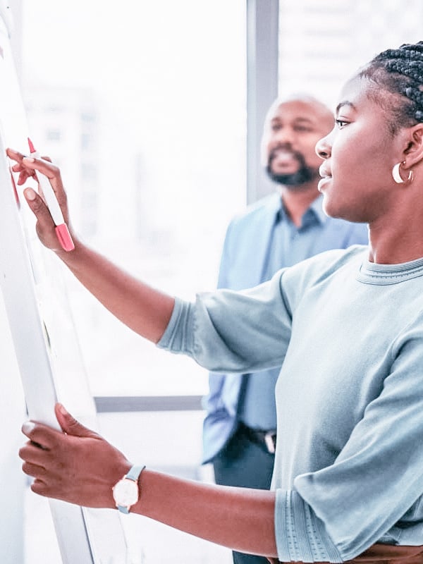 Woman presenting on a white board_filter_450x600
