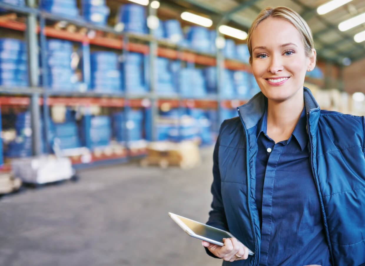 Lady in warehouse using SAP Business One on tablet