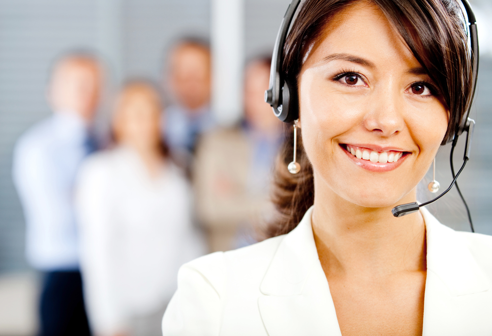 Female customer support operator with headset and smiling